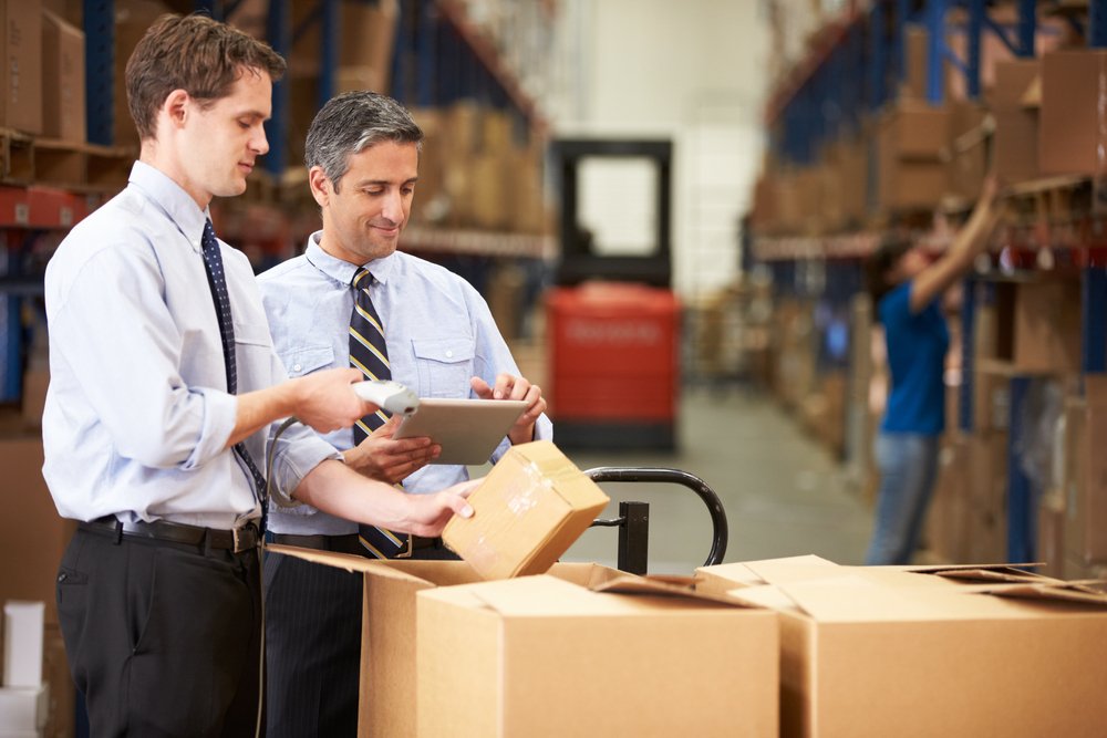 Businessmen Checking Boxes With Digital Tablet And Scanner